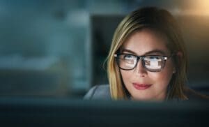 A woman focuses on a computer screen