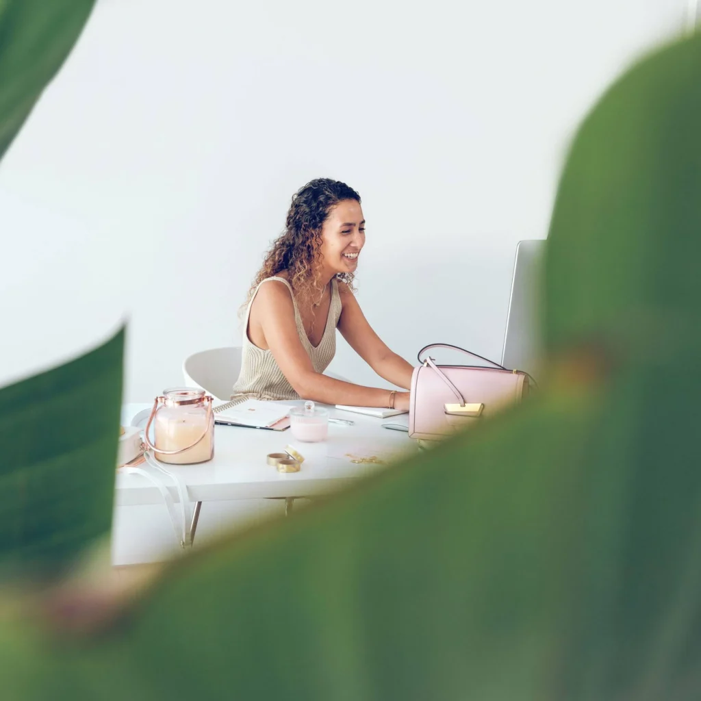 A positive female worker typing on keyboard