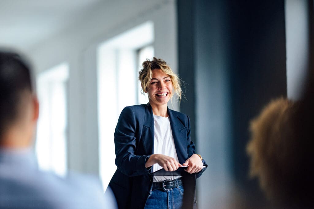 A women smiles while holding a tablet